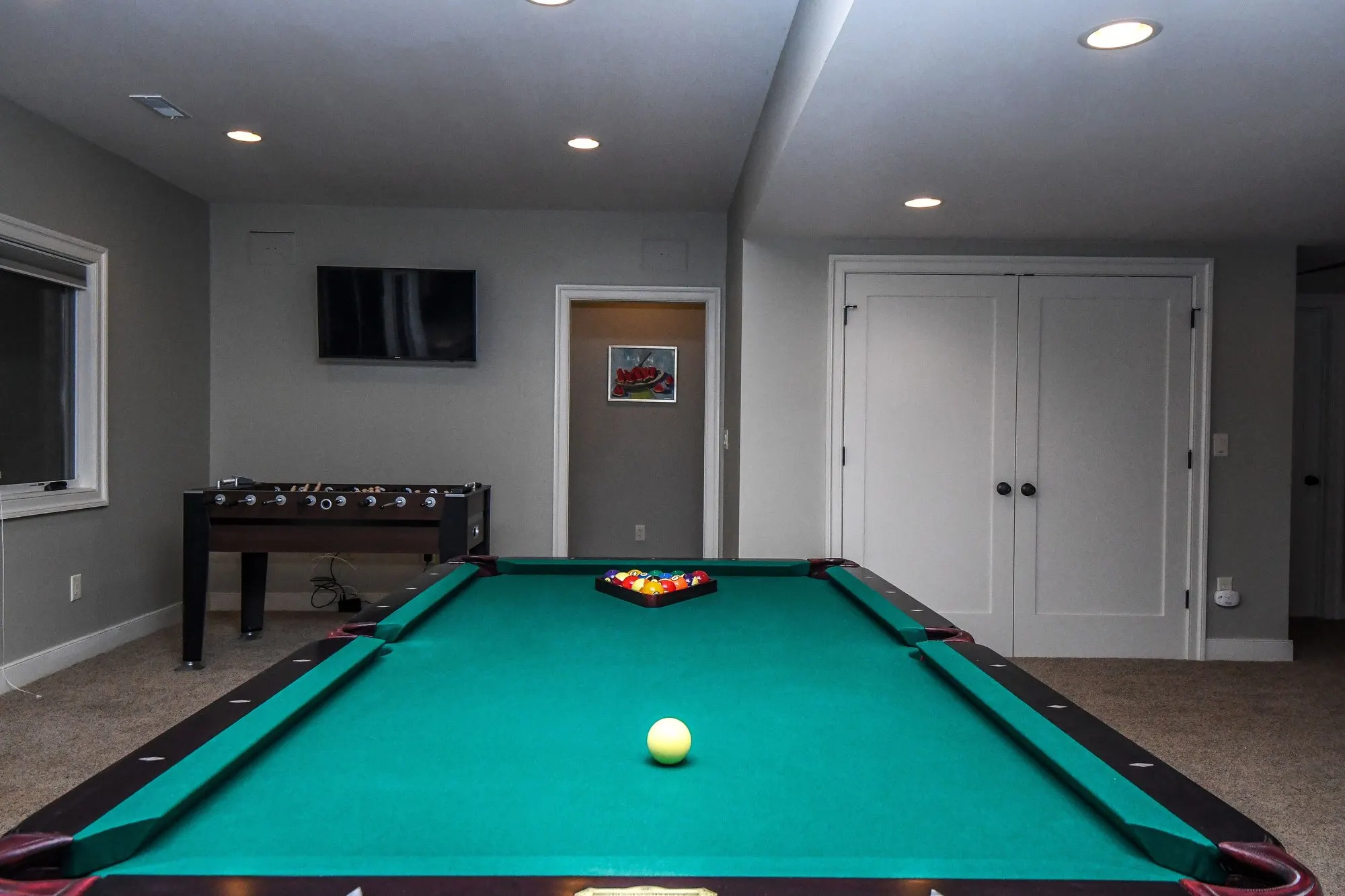 Game room with the pool table and foosball table at Woodland Chalet