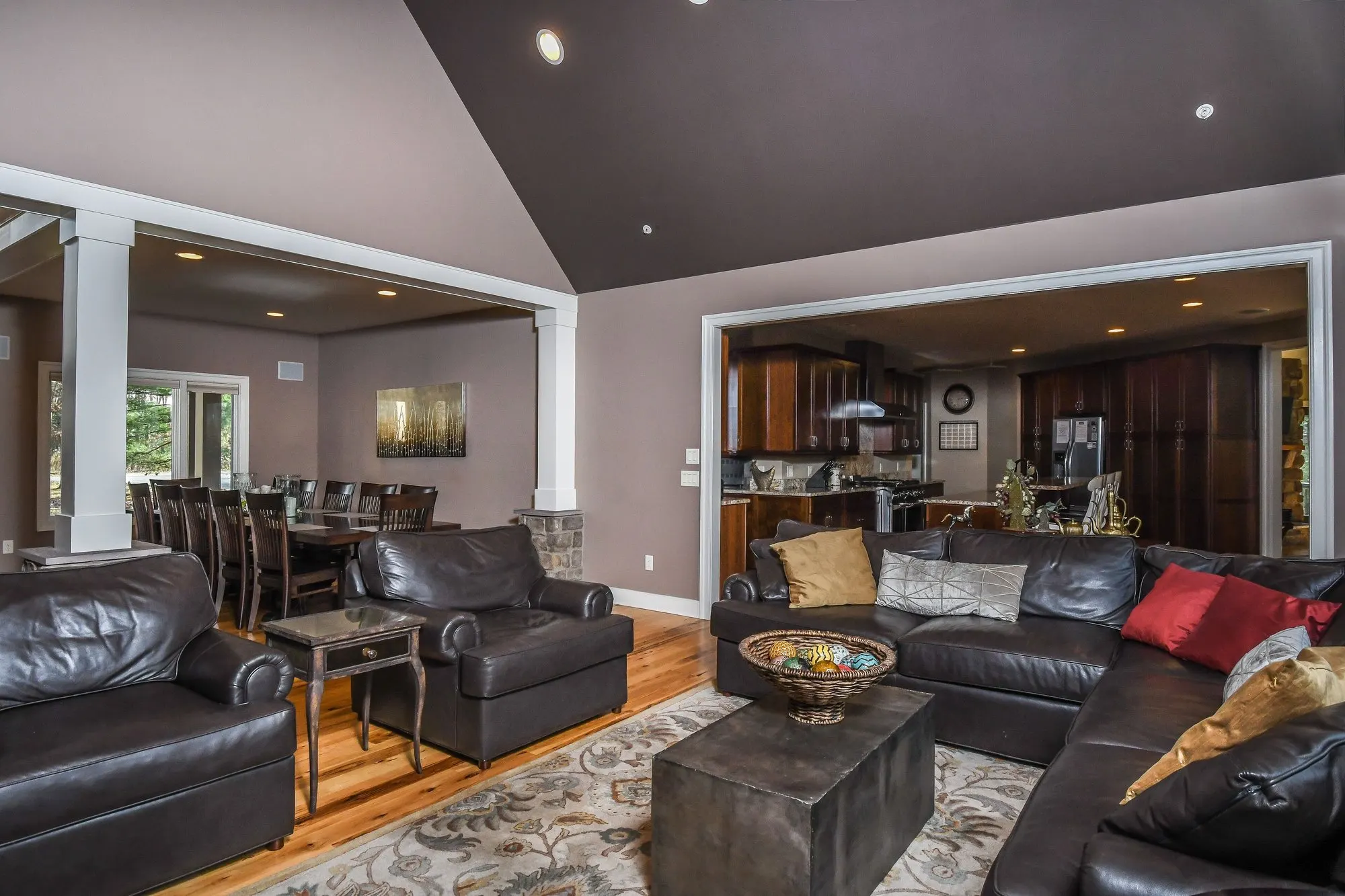 Great room opening toward the kitchen through the columns at Woodland Chalet