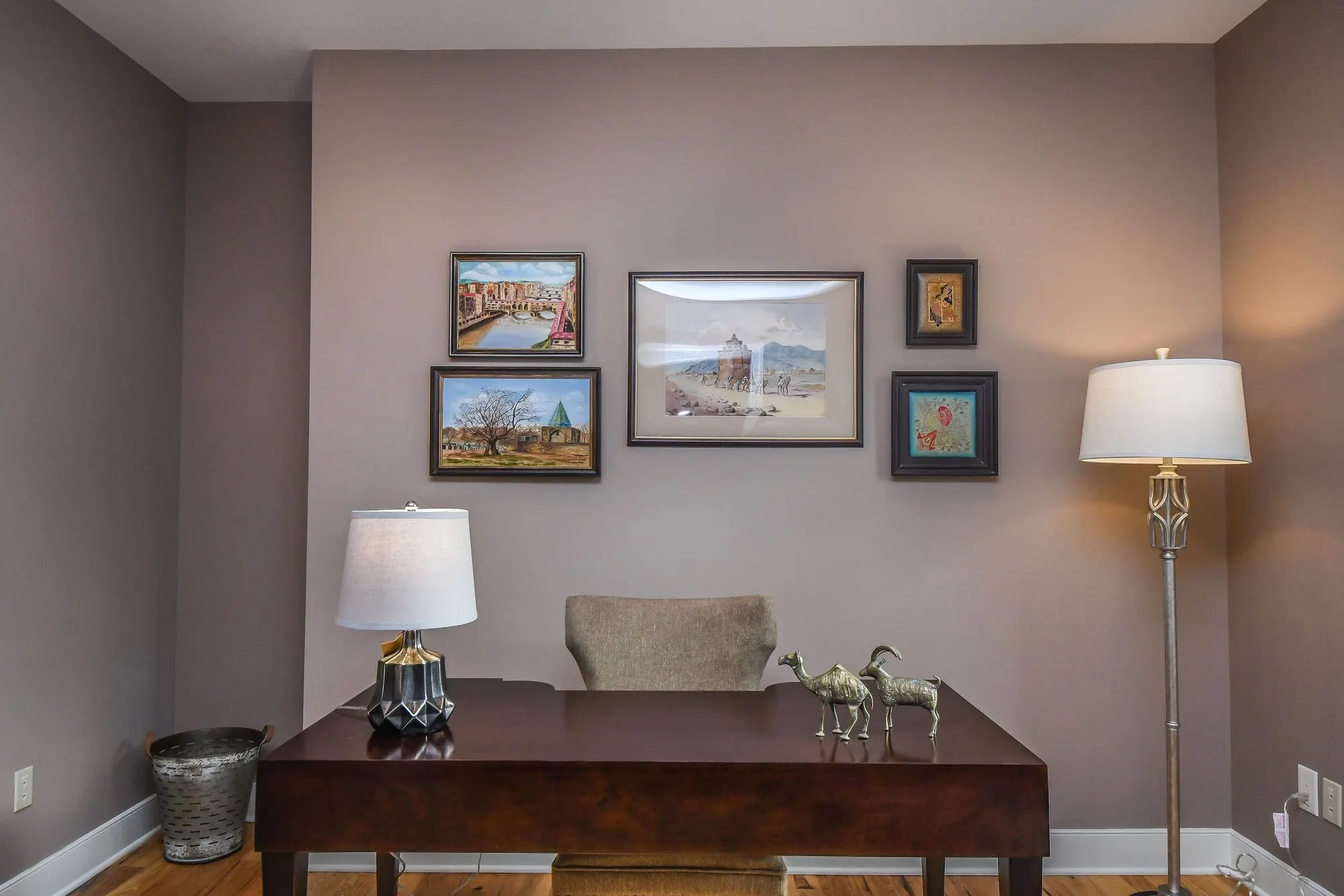 Home office desk with framed art on the wall