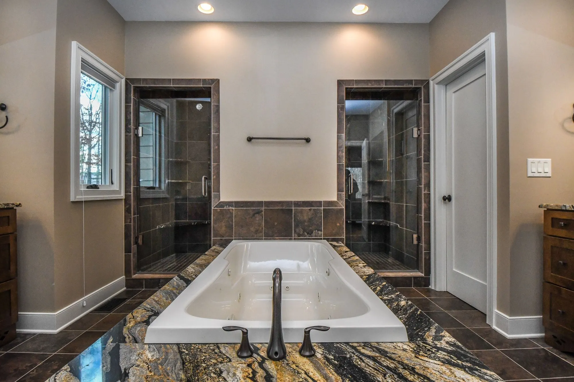 Primary bath jetted tub between the dual showers