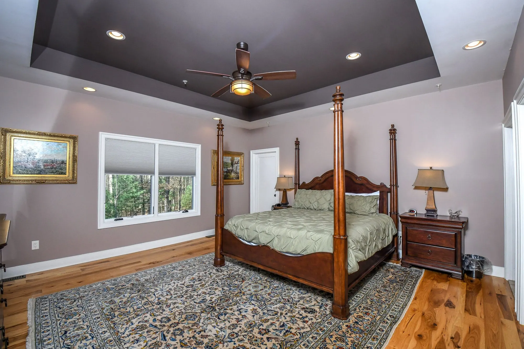 Primary suite four-poster bed from the doorway