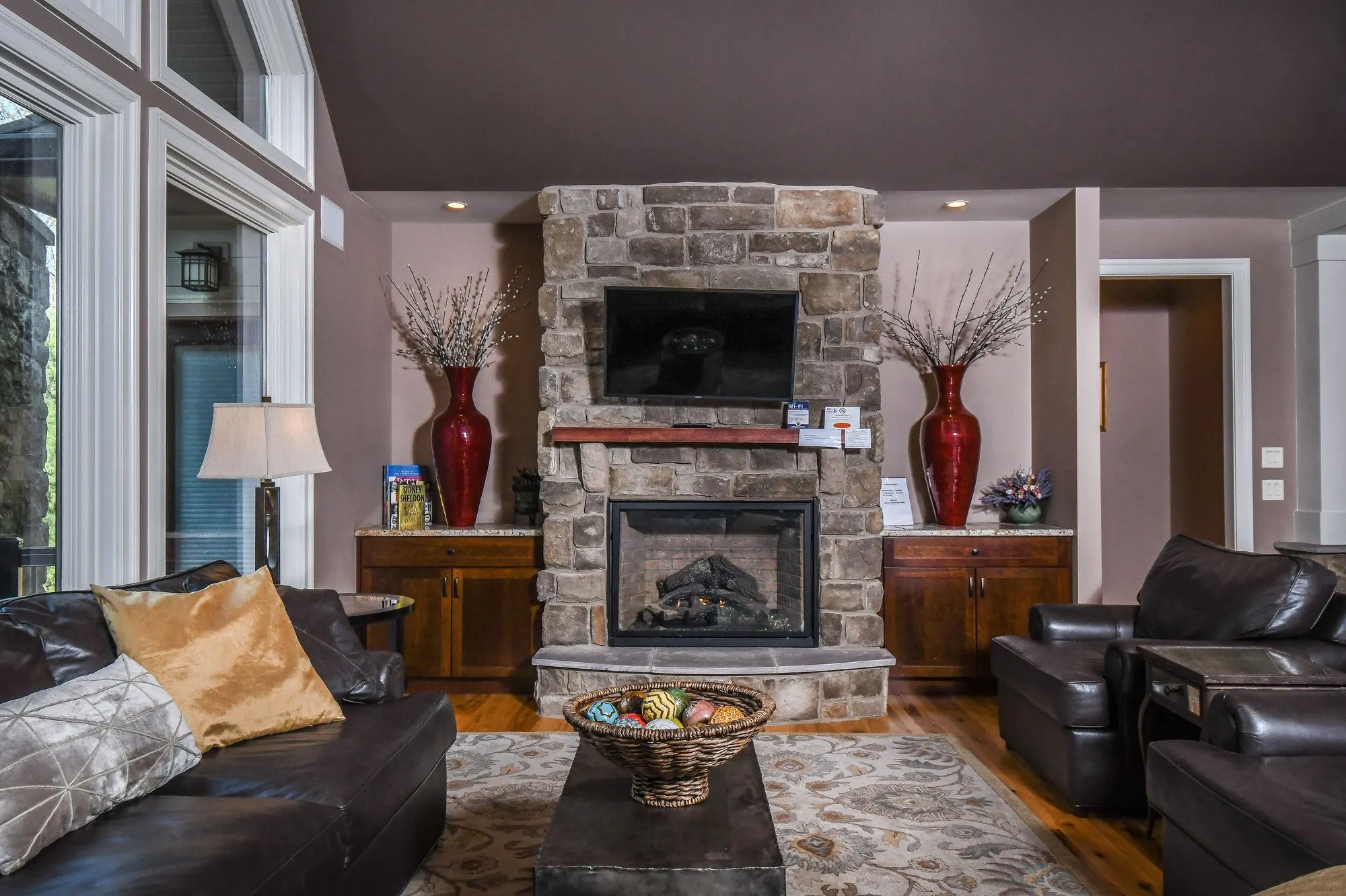 The sitting room at Woodland Chalet with its corner stone fireplace