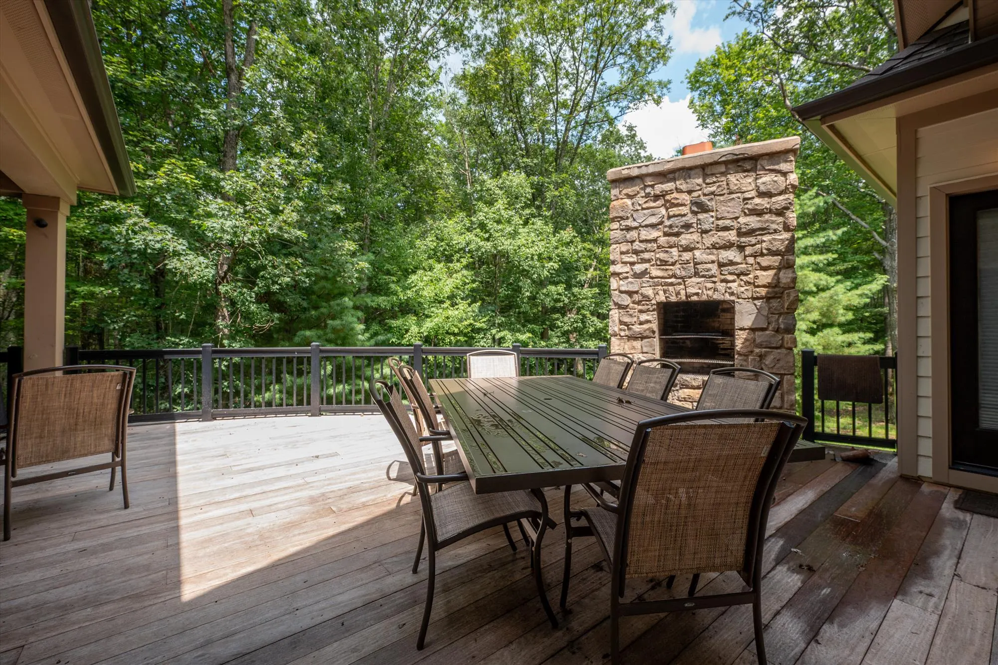 Expansive main deck with outdoor dining furniture and mountain views