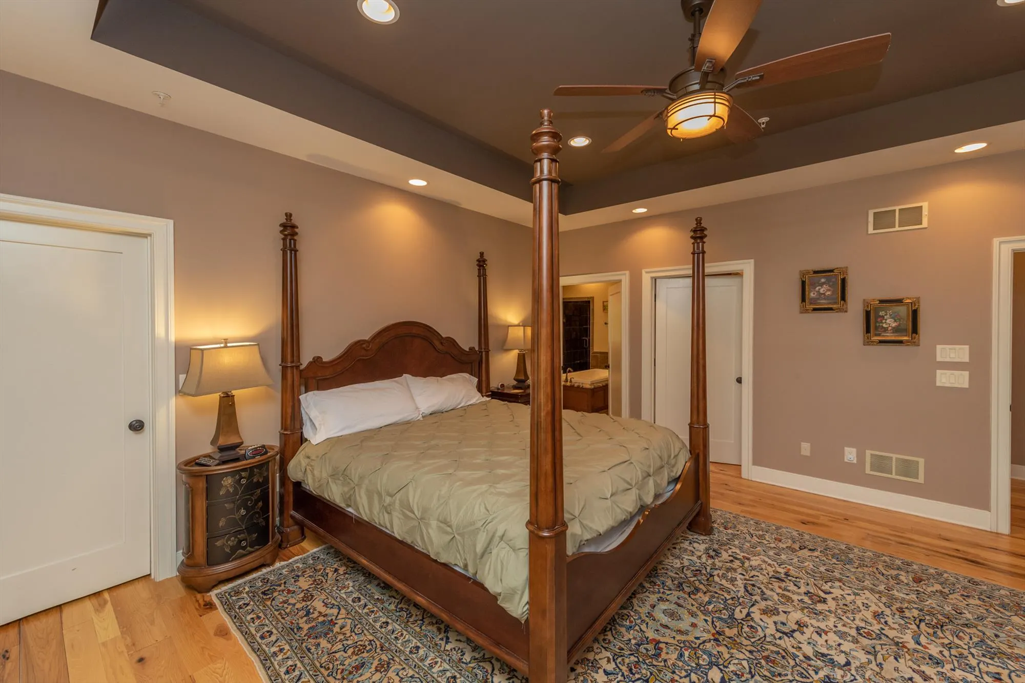 Main level primary suite with king bed and elegant furnishings at Woodland Chalet