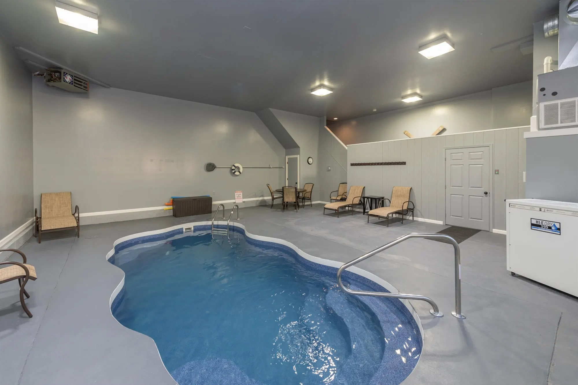 Indoor pool room with ample natural light in the 30-by-28-foot pool house