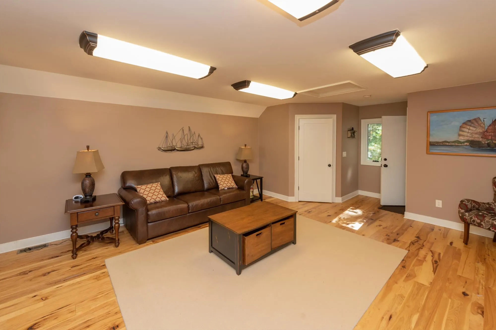 Spacious 30-by-16-foot upper lounge in the pool house with full bathroom