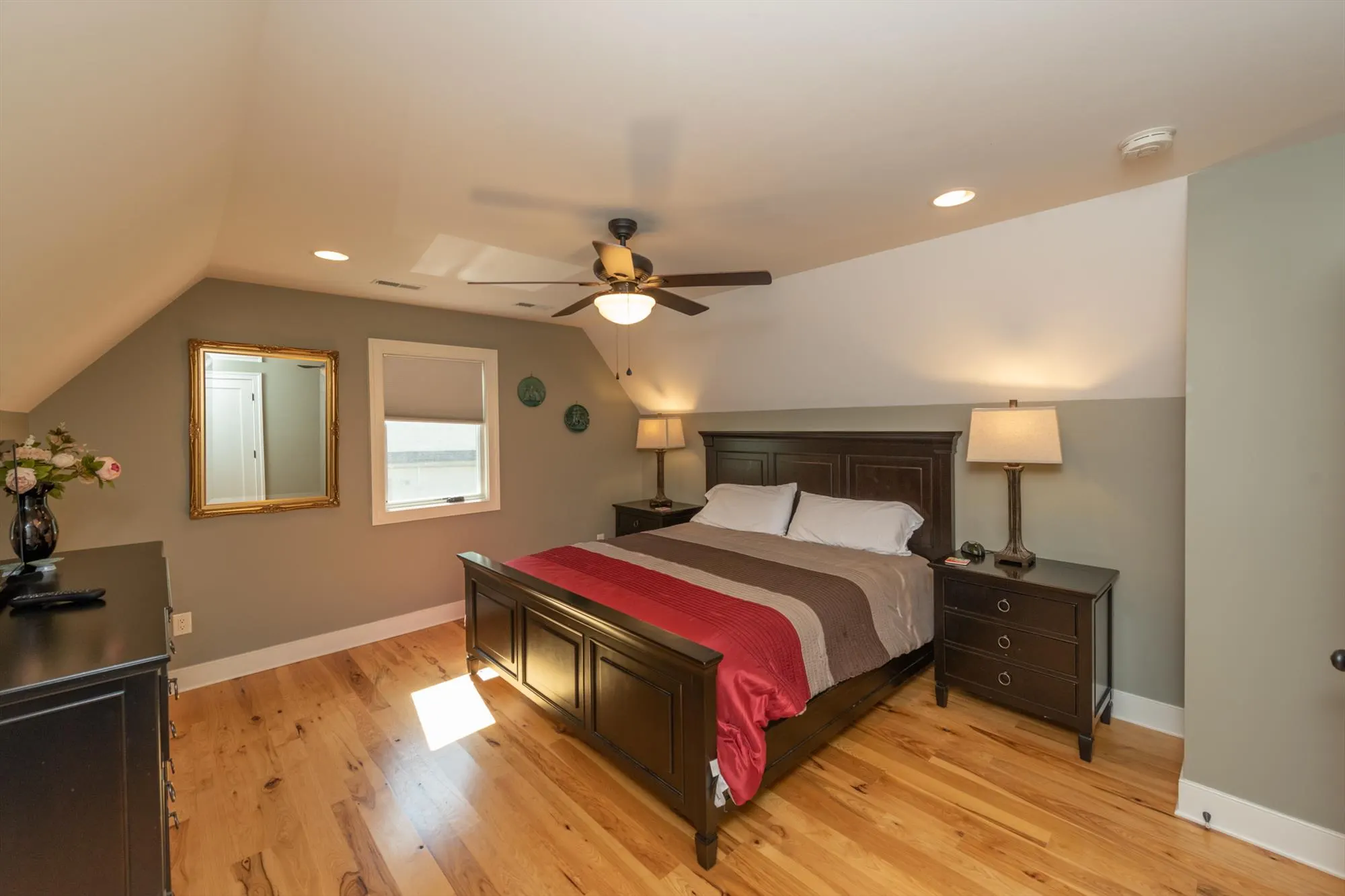 Upper level bedroom alternate view showing spacious layout and decor